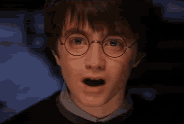 a close up of harry potter wearing glasses with his eyes closed .