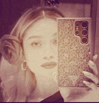 a woman taking a selfie with a phone that has a guess logo on it