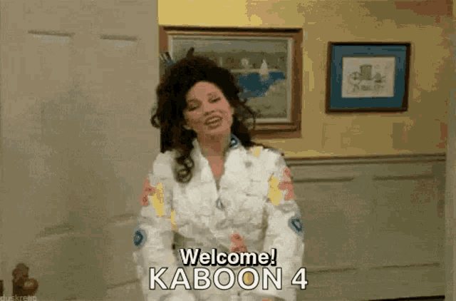 a woman is standing in front of a wall and says welcome kaboon 4