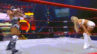 two women are wrestling in a wrestling ring and one of them is wearing knee pads .