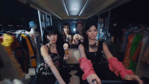 a group of women holding ice cream cones in a room