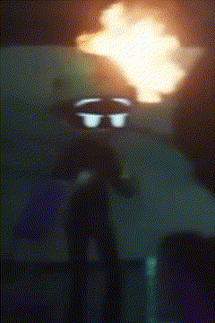 a blurred image of a person standing in front of a flame