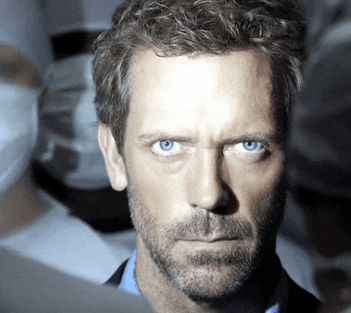 a close up of a man 's face with blue eyes and a beard