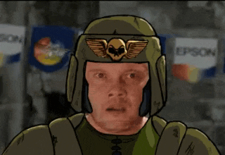 a man wearing a green helmet with a skull on it