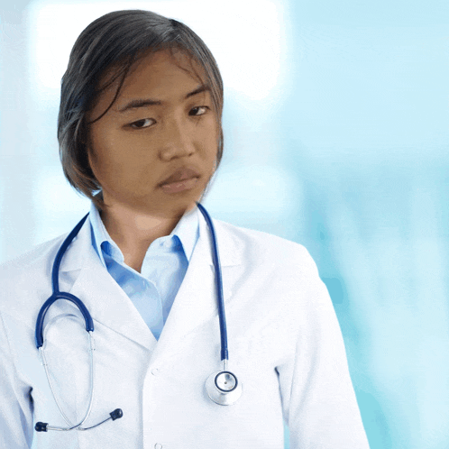 a female doctor wearing a white coat and a stethoscope around her neck