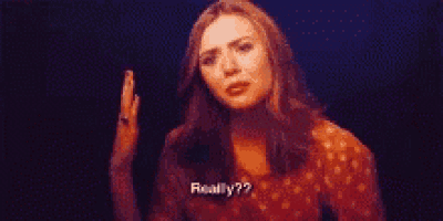 a woman in a red dress is making a funny face and says `` really ? ''