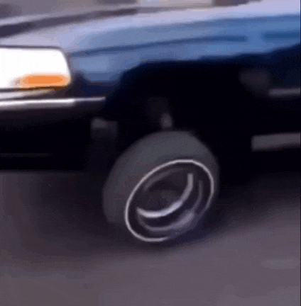 a close up of a car 's wheel with a white rim