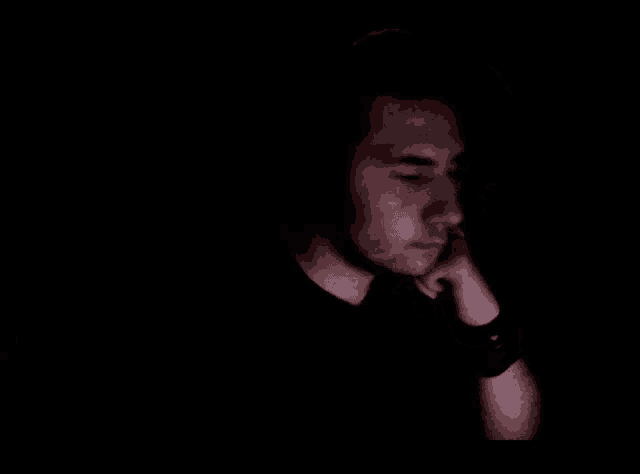 a man wearing headphones is making a peace sign with his finger