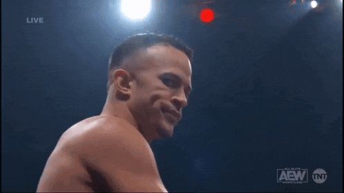 a man is smiling in front of a screen that says live