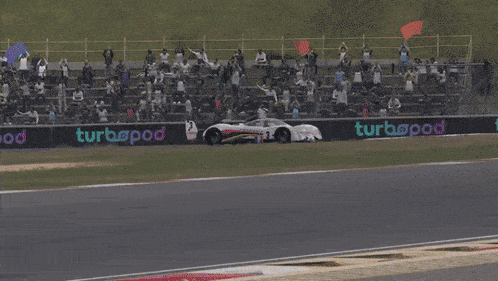 a peugeot race car is driving down a track