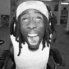 a black and white photo of a man wearing headphones and a headband with his mouth open .