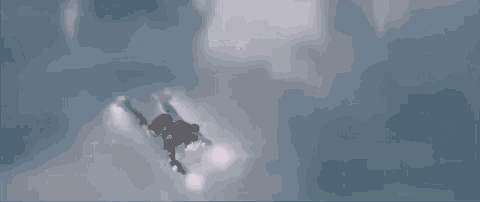 a man is flying through the air in a cloudy sky .