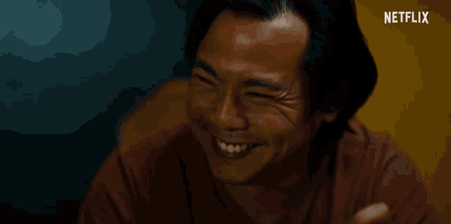 a man is smiling with a netflix logo in the corner