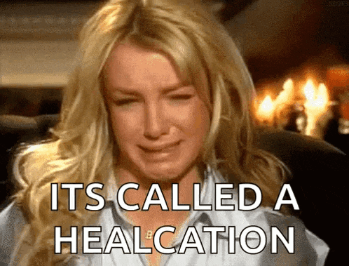 a woman is crying with the words " it 's called a healcation " on her face .