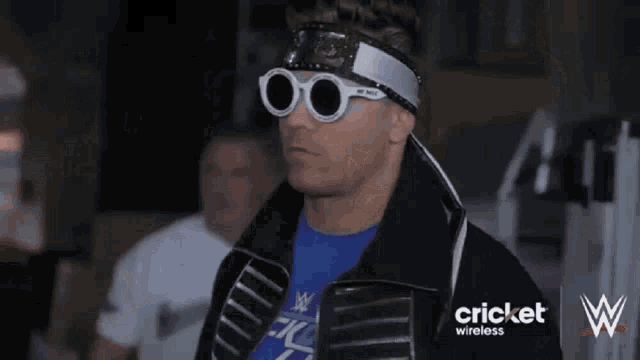 a man wearing sunglasses and a headband with the word cricket wireless on it