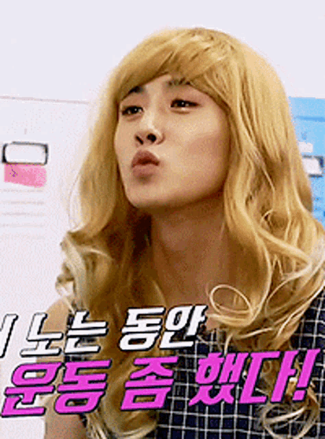 a man with blonde hair is wearing a wig and making a face