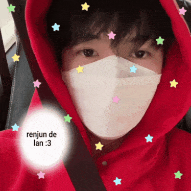 a person wearing a red hoodie and a white face mask with renjun de lan written on it