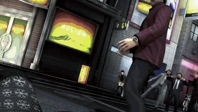 a man in a red jacket stands in front of a building that says aulium