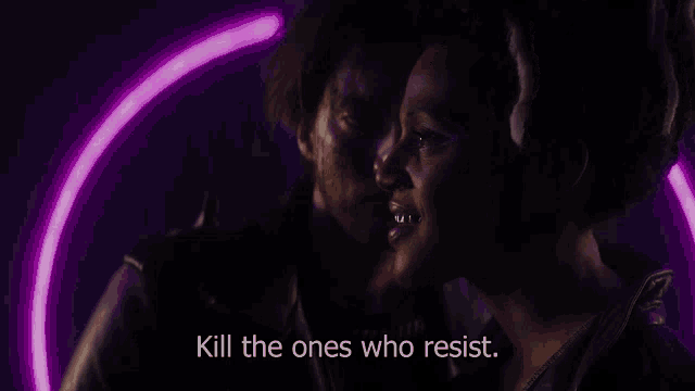 a man and a woman in a dark room with the words kill the ones who resist on the screen