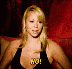 a blonde woman in a black bra is saying no
