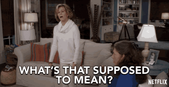 two women sitting on a couch with the words what 's that supposed to mean written below them