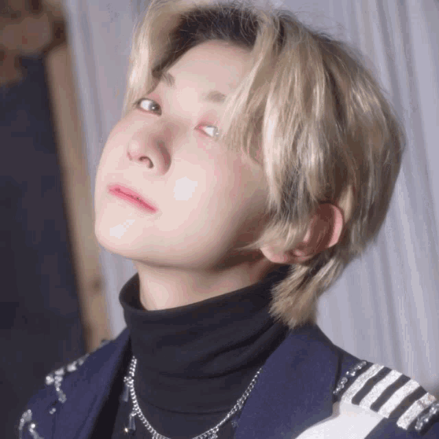 a close up of a person wearing a turtleneck