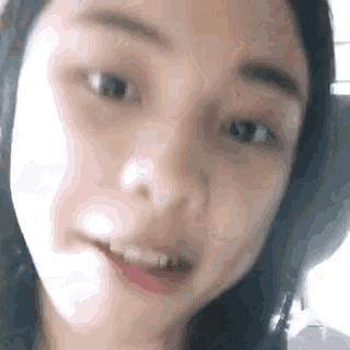 a close up of a woman 's face with her mouth open and a tooth missing .