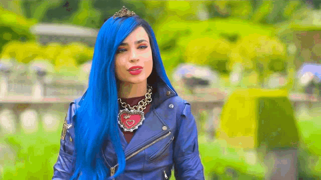 a woman with blue hair is wearing a tiara and a leather jacket