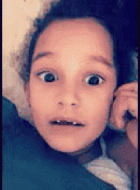 a young girl with a surprised look on her face .