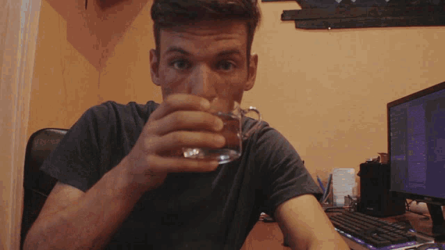 a man drinking from a glass with the word i 'm visible