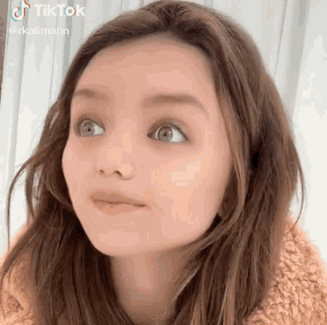 a close up of a woman 's face with a funny face .