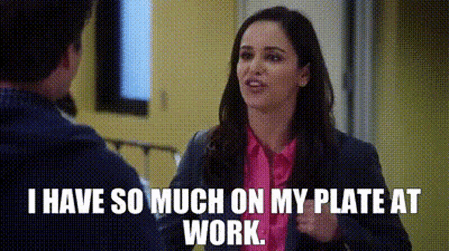 a woman is talking to a man and saying `` i have so much on my plate at work '' .