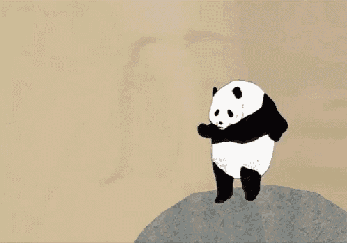 a panda bear is standing on top of a large rock .