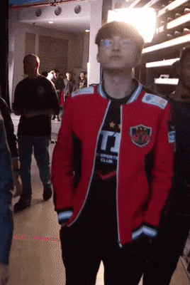 a man wearing a red jacket that says t1 on it