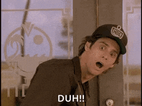 a man wearing a baseball cap is standing in front of a door with his mouth open and a surprised look on his face .