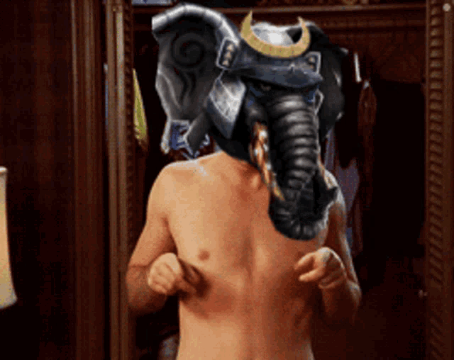 a shirtless man wearing an elephant mask