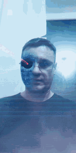 a man is wearing glasses and a mask with a red light coming out of it