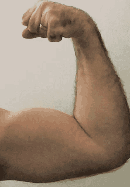 a close up of a man 's arm with a fist in it
