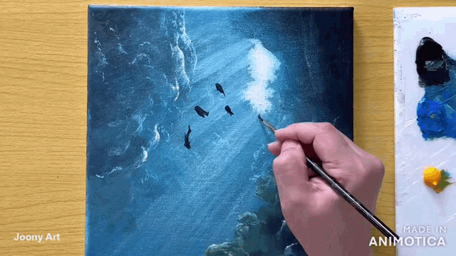 a painting is being painted on a canvas with the words made in animatica at the bottom