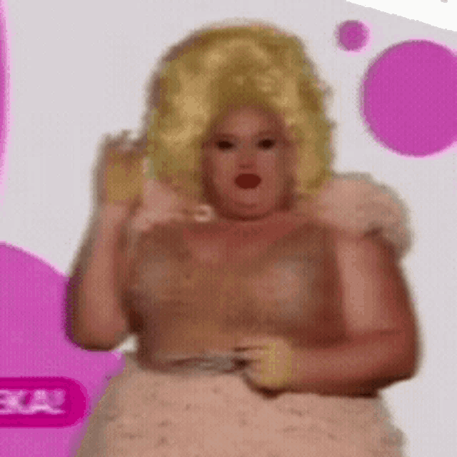 a woman wearing a wig and a white dress is standing in front of a pink background .