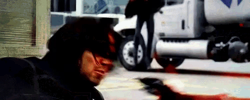 a man is laying on the ground with blood coming out of his mouth .