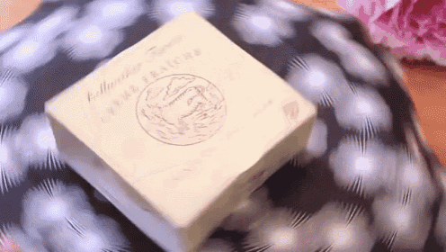 a box of creme fraiche sits on a polka dot cloth
