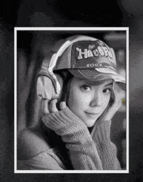 a woman wearing headphones and a hat that says " rock "
