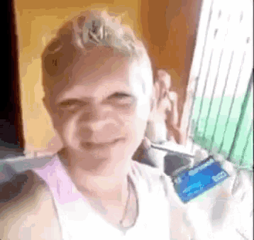 a woman is making a funny face while holding a credit card in her hand .