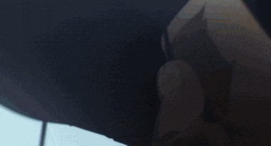 a person is laying on their back with their head on the ground and their arms outstretched .