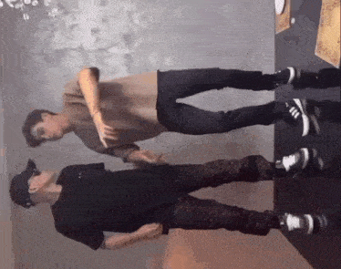two men are standing next to each other in a room and one of them is wearing sunglasses