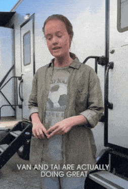 a girl standing in front of a trailer with the words van and tai are actually doing great below her