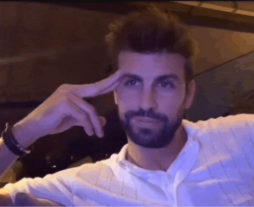 a man with a beard is making a funny face with his hand on his forehead