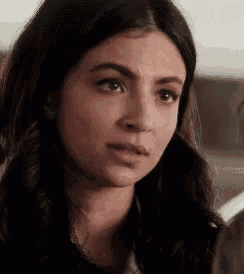 a close up of a woman 's face with a serious expression on her face .