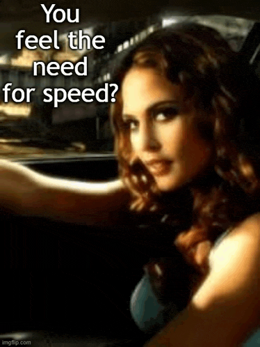 a woman is sitting in a car with the words `` you feel the need for speed '' written on the bottom .